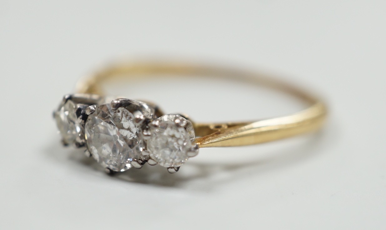 An 18ct and three stone diamond set ring, size, T/U, gross weight 2.9 grams